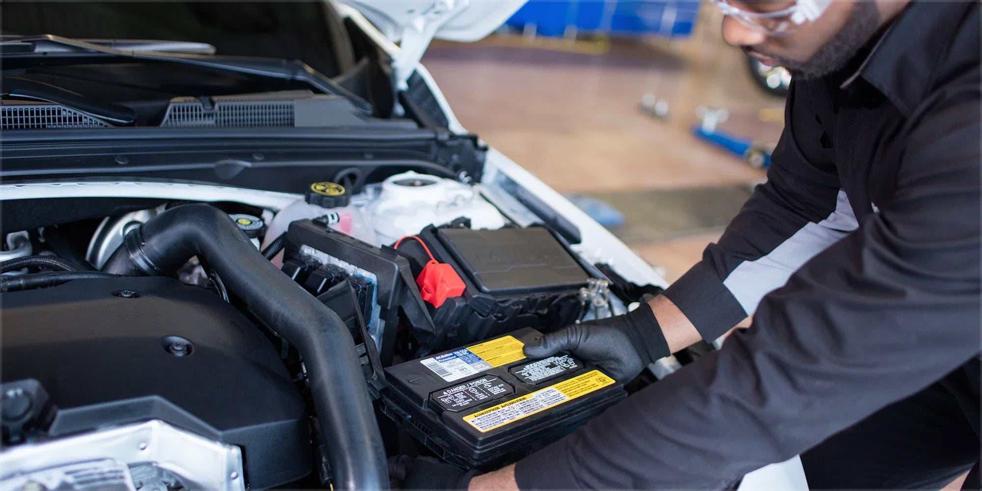 Mechanic replacing a car battery